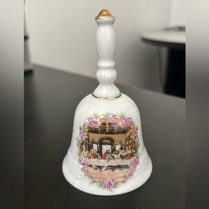 A vintage porcelain bell depicting The Last Supper with gold trim